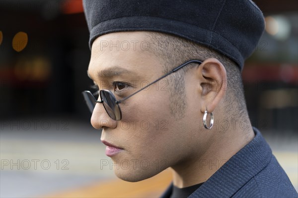 Closeup Portrait Of Latin Gay Male With Makeup Wearing Fashion Hat