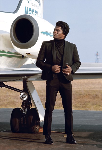 James Brown standing by his private airplane at the Long Island airport.