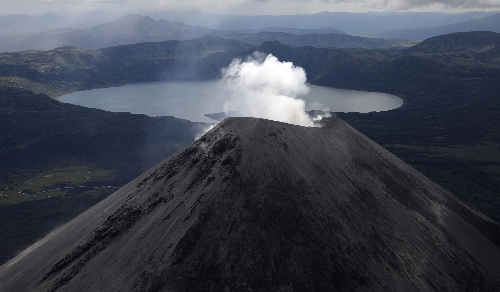 Bird's eye view of smoking Karymsky volcano