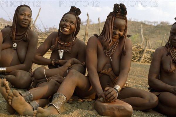 OVA HIMBA MOTHERS AND BABIES, CRUSHING OCHRE, NORTHERN NAMIBIA