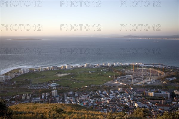 Seen from Signal Hill, construction cranes rise above the site of the new Greenpoint Stadium in Greenpoint, Cape Town. The all-weather stadium is designed to seat 70,000 people. The Stadium is one of 10 that will be used in the 2010 FIFA World Cup, 2010 Soccer World Cup