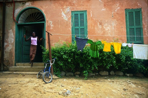 Rokhaxa Samaké runs out of her home - Rue St Germaine, Ile De Gorée, Rep. De Senegal