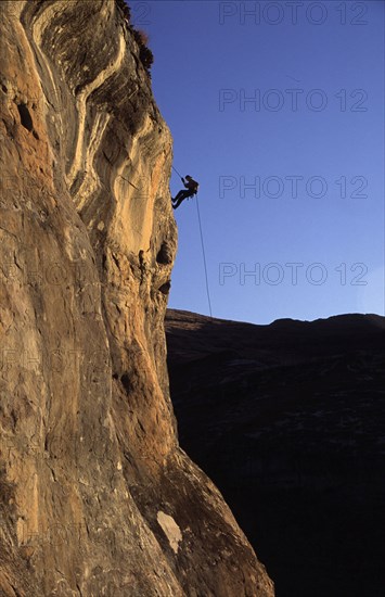 abseiler silhouetted against the sky