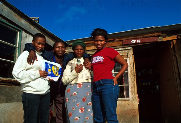 Residents of Silahliwe pose for the camera outside one of their shacks. Ukuthasa worked hard to get this land allocated to them by authorities. Recently, however, the residents have been told they will have to move again.