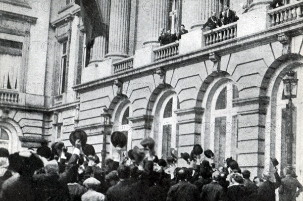 Exchanging the crepe drapery for flags and flowers