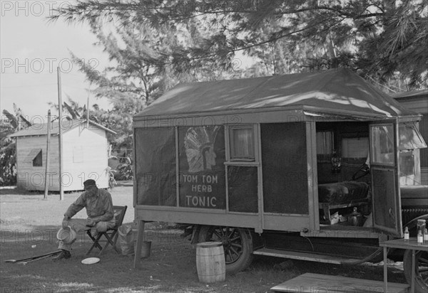 One-legged medicine man encamped with the migrant fruit and vegetable workers at Belle Glade, Florida, dated 19370101