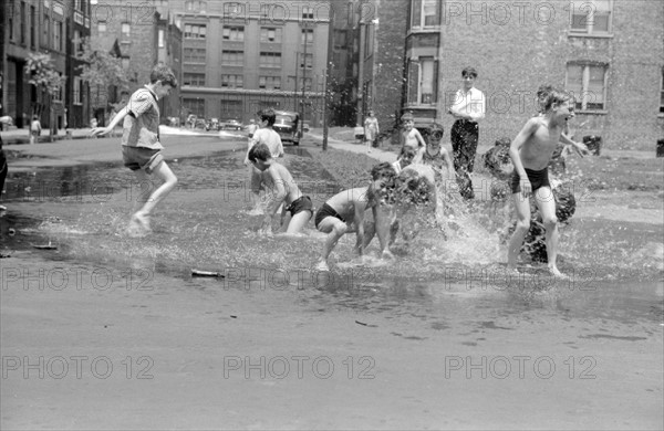 Untitled. Cooling off in water from hydrant, Chicago, Illinois July 1941.