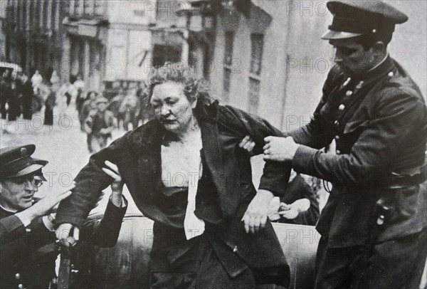 Spanish woman helped by assault guards in Madrid.