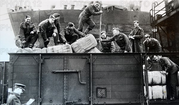 British soldiers load supplies at a railway depot in northern France, 1940