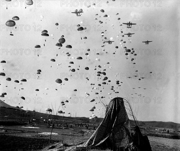 Photograph of Paratroopers of the 187th RCT parachuting