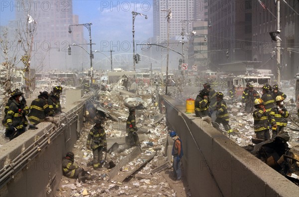 Colour photograph of New York Firefighters amid the rubble of the World Trade Centre following the 9/11 attacks