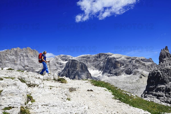 Hiker above the Bullele-Joch-Hutte and the summit of the Einser