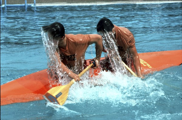 Two wet paddlers in a kayak ca. 1970s