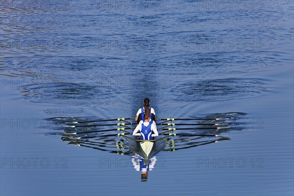 Rowers rowing in rowing boat