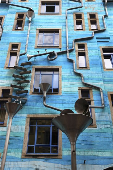 Blue house facade with rain pipes