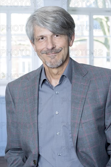 Man standing in front of an office window