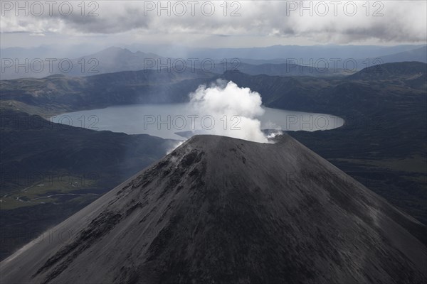 Bird's eye view of smoking Karymsky volcano