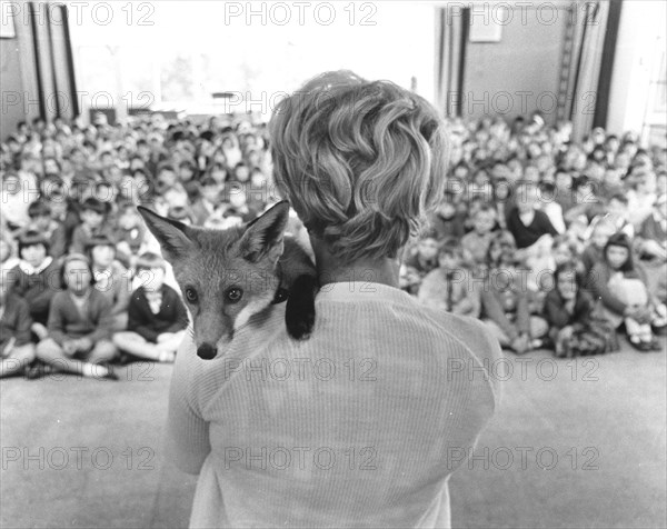 Woman with fox on her shoulder