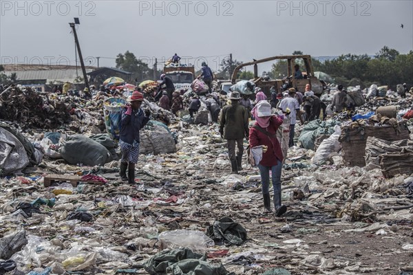 Garbage collectors on rubbish dump on the outskirts