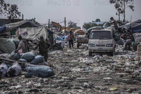 Garbage collectors on rubbish dump on the outskirts