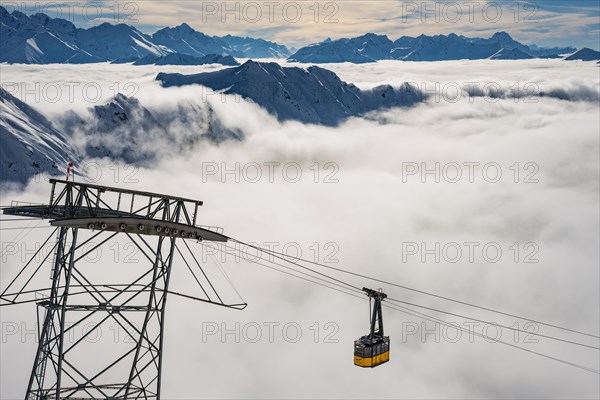 Mountain peaks protrude from clouds