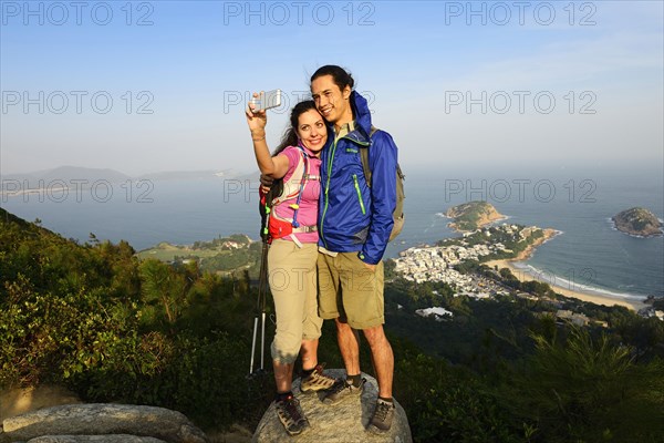 Hikers taking a selfie on a rock