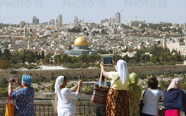 Women photograph the Dome of the Rock