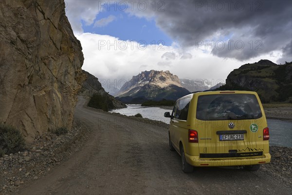 Yellow travel minibus on road to Lago del Desierto at Rio de las Vueltas