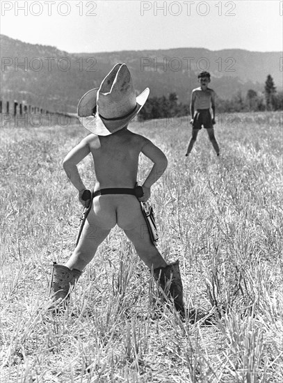 Two boys playing Cowboy