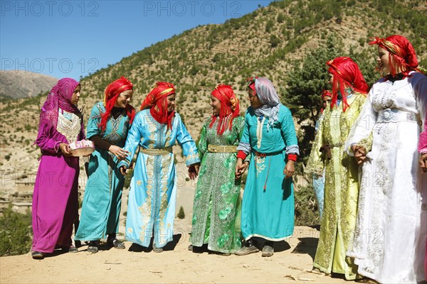 Dancing women in colorful dresses