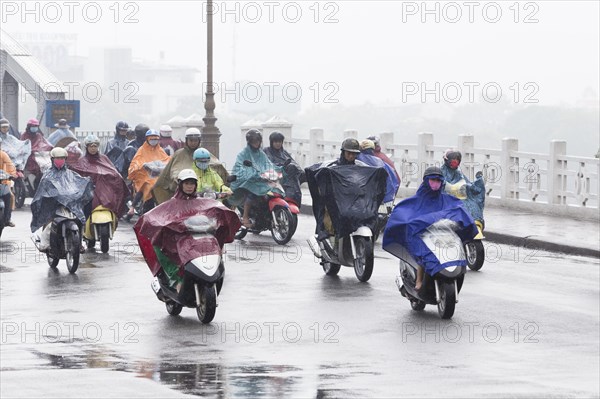 Mopeds on street during rain