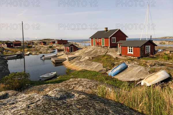 Red wooden houses on the rocky coast