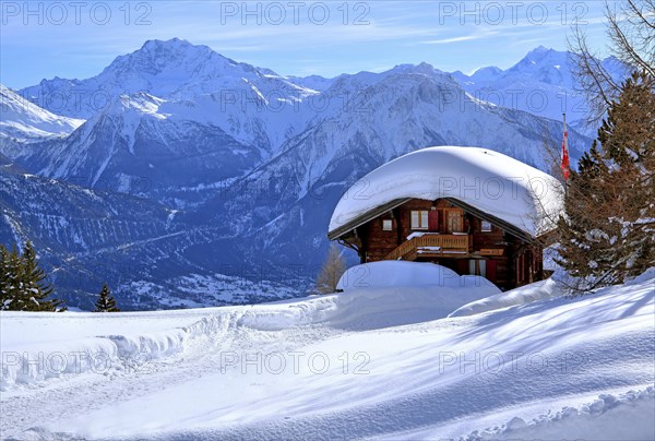 Winter landscape with deep snow-covered chalet in front of Fletschhorn 3985m and Dom 4545m