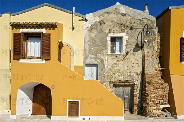 Decayed and renovated house next to each other