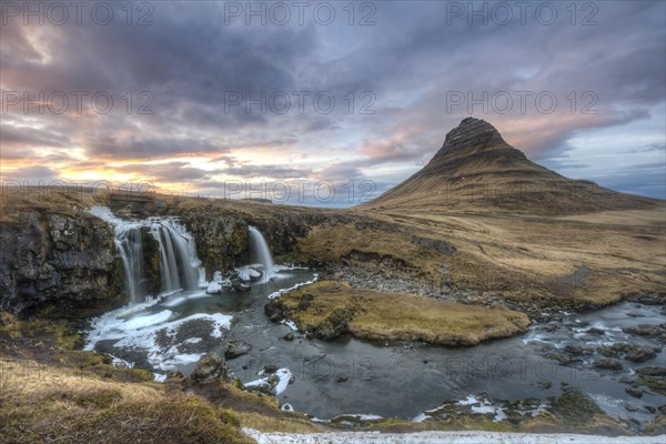 Kirkjufell mountain with Kirkjufellfoss waterfall at sunset