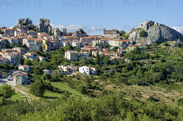 View of mountain village Pietrabbondante with medieval tower and church Chiesa di Santa Maria Assunta on rock Morg Caraceni