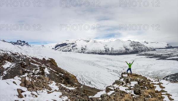 Hiker stretches his arms up