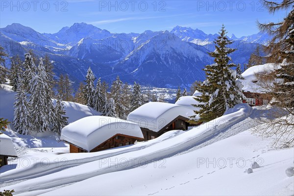 Winter landscape with deep snow-covered chalets