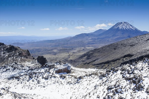 View from Mount Ruapehu on Mount Ngauruhoe with a ski cottage in the foreground