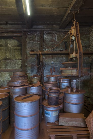 Production room for bronze powder with barrels and machines in a historical metal powder factory