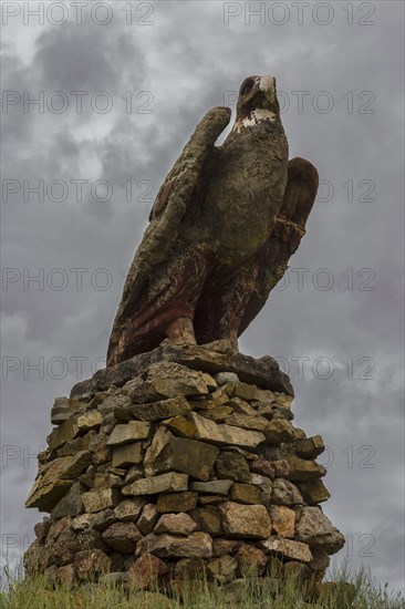 Golden eagle made of stone along the road