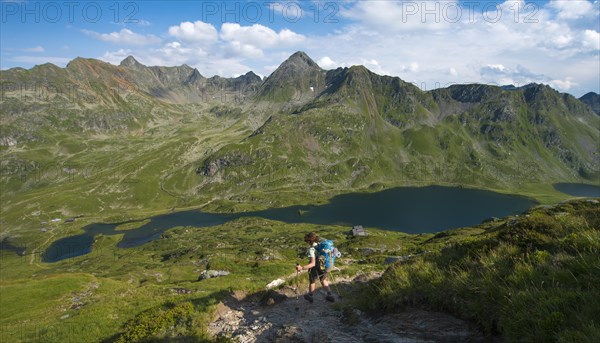 Hiker on the way to the mountain hut Ignaz-Mattis-Hutte