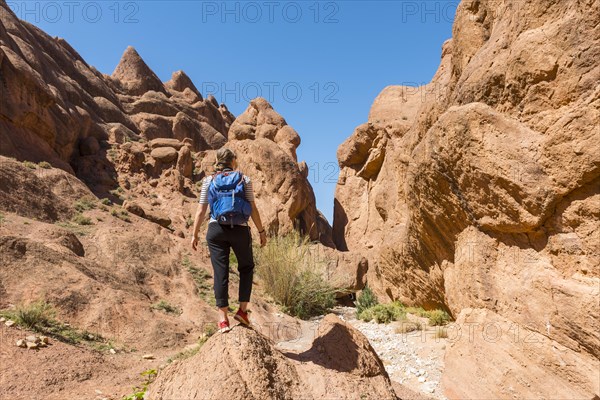 Young female hiker in a narrow sandstone canyon