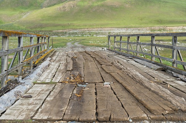 Old wooden bridge over a Mountain river