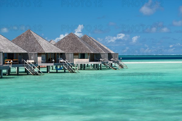 Wooden huts on stilts in lagoon