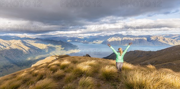 Female hiker stretching arms in the air