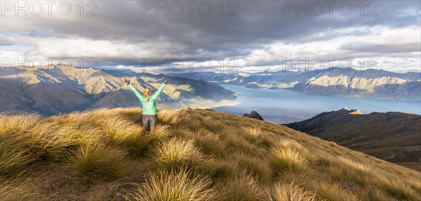 Female hiker stretching arms in the air