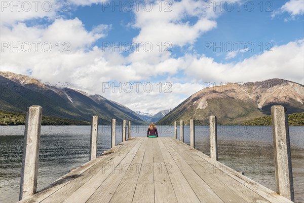 Woman sitting on dock