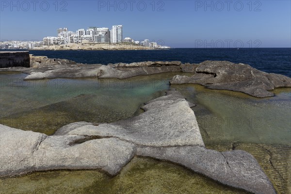 Bizarre rocky coast with natural water basins