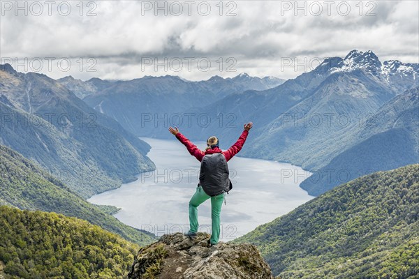 Female hiker is looking at the South Fiord of Lake Te Anau